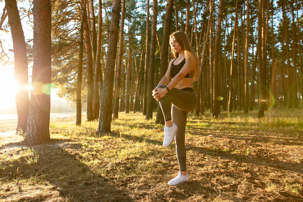 gorgeous-female-runner-doing-stretching-exercise-workout-wood-sun (1).jpg